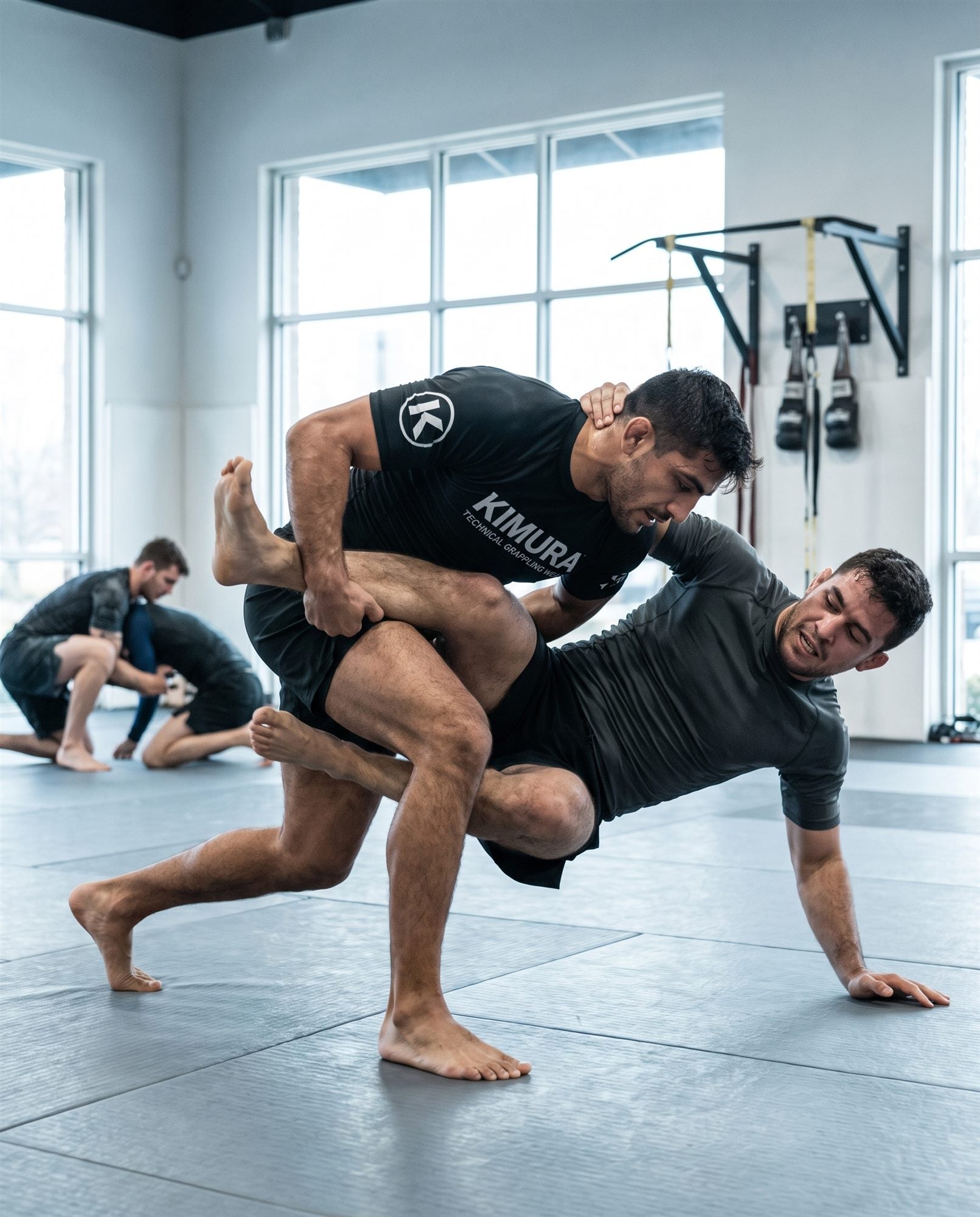 Kimura athlete executing a single-leg takedown